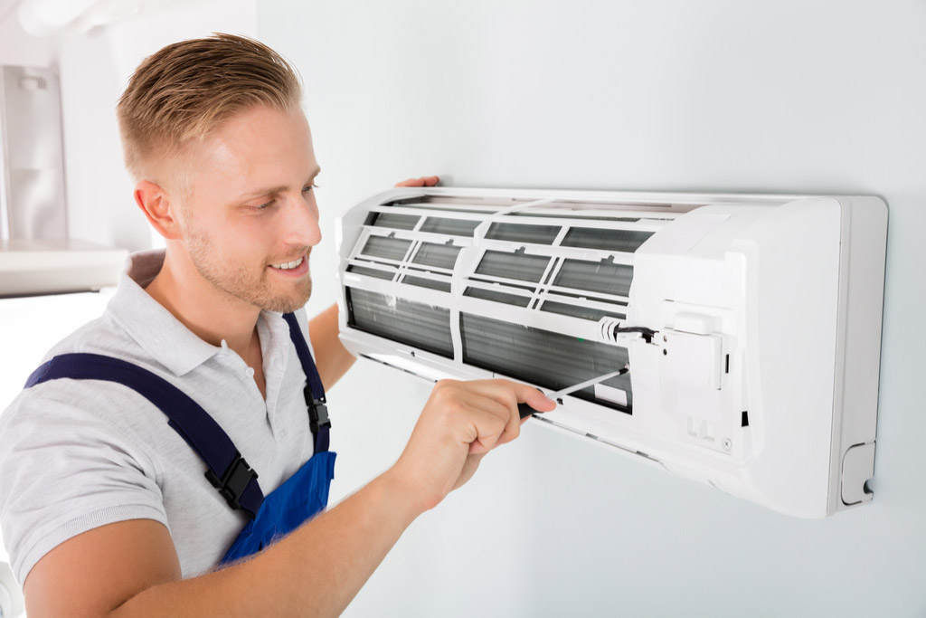 HVAC technician maintaining a ductless air conditioner in Irvine