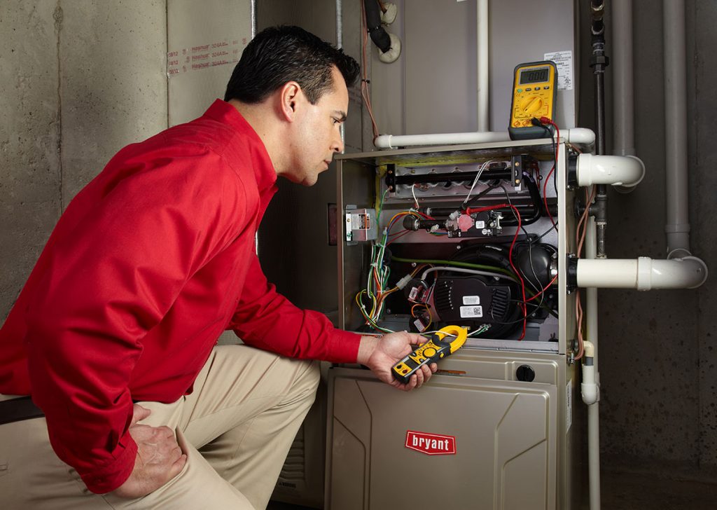 Heating technician diagnosing a furnace repair in Irvine
