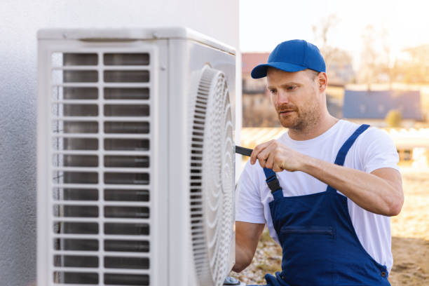 HVAC technician servicing an outdoor air conditioner in Irvine